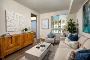Model living room at Alta Merita Apartments in Rancho Cucamonga, featuring wood grain floor paneling.